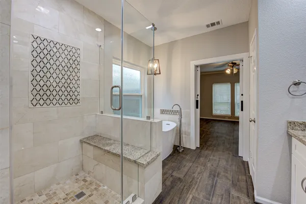 a bathroom with a sink a toilet and shower