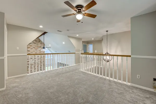 wooden floor in a hall with a ceiling fan