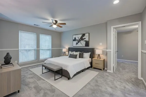 a bedroom with a bed and a large window