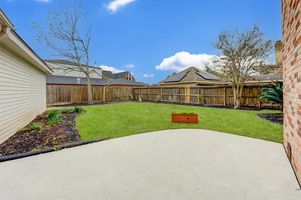 a view of a big house with a big yard and potted plants