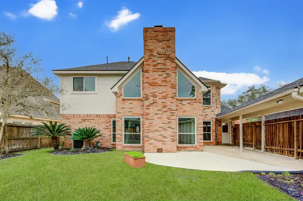 a front view of a house with a yard and porch