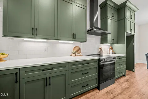 a kitchen with stainless steel appliances granite countertop a sink a stove and cabinets