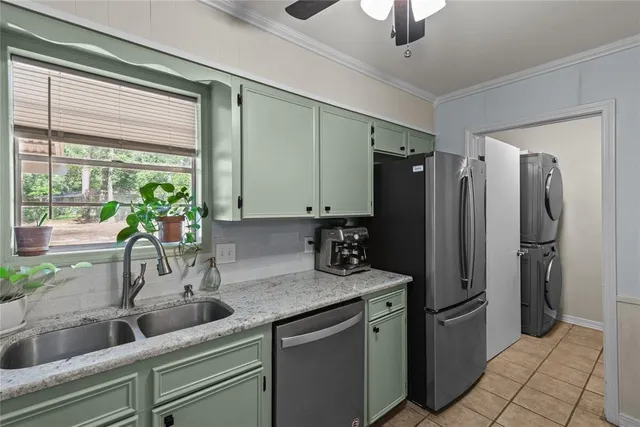 a kitchen with stainless steel appliances granite countertop a refrigerator and a sink