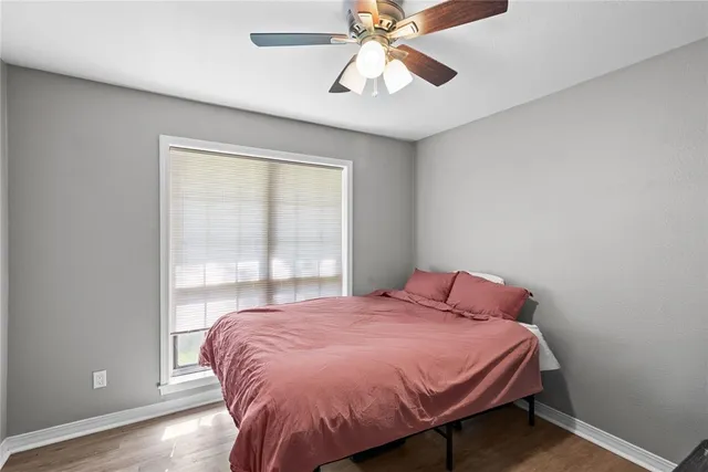 a bed sitting in a bedroom next to a window