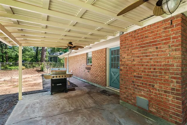 a view of patio with table and chairs