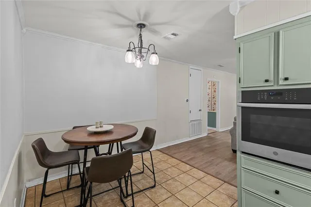 a view of a room with breakfast area and chandelier