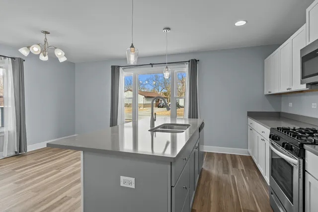 a view of wooden floor and chandelier in living room