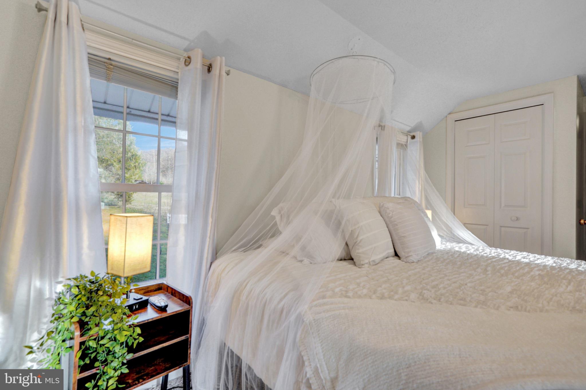259 A A-Frame Road Coudersport, PA 16915 - Photo 41 of 130 Serene bedroom with natural light.