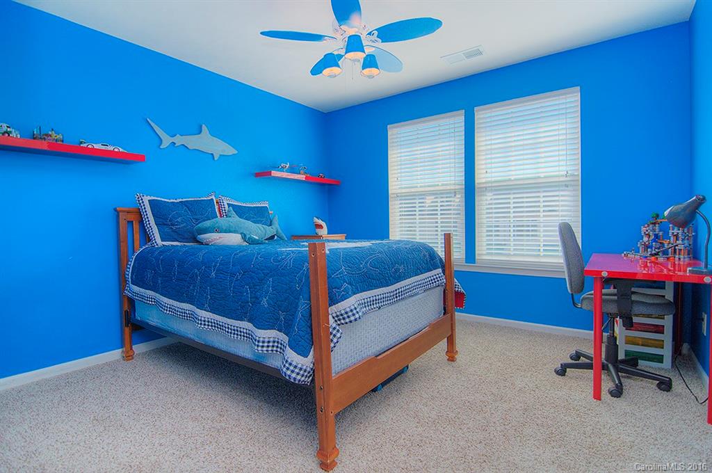 129 Inlet Point Drive, Unit 72 Tega Cay, SC 29708 - Photo 14 of 20 a bedroom with a bed and a table