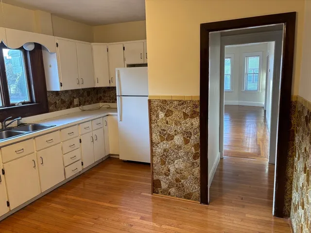 a kitchen with stainless steel appliances a refrigerator sink and cabinets