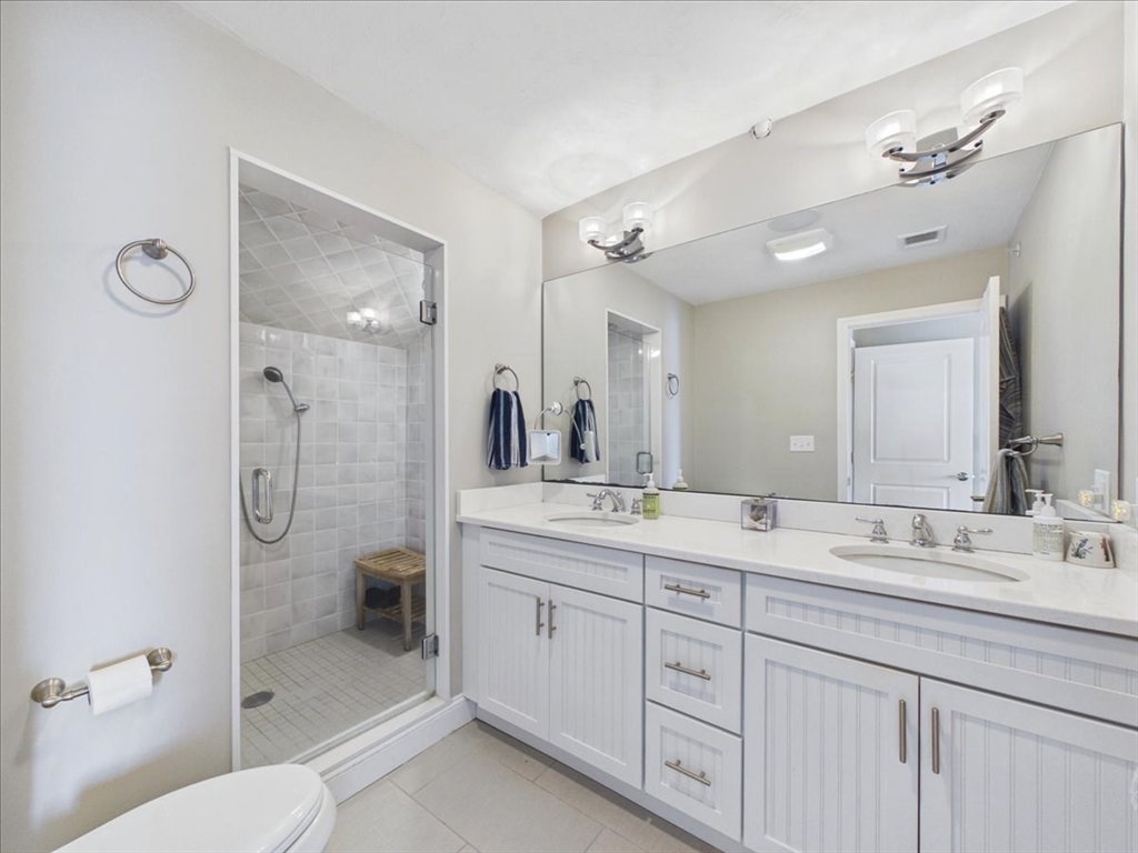 7 Bay Street, Unit 3 Hull, MA 02045 - Photo 29 of 40 a bathroom with a granite countertop sink mirror toilet and shower