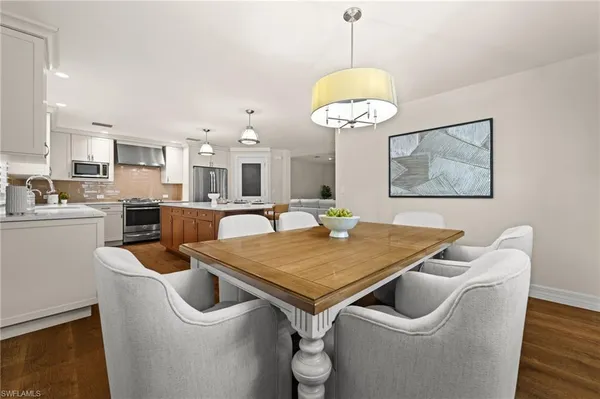 a view of a dining room with furniture wooden floor and chandelier