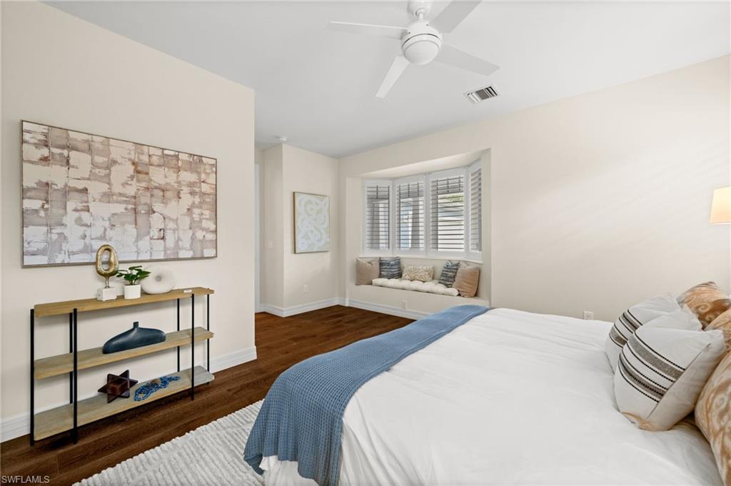 2499 10th Street North Naples, FL 34103 - Photo 18 of 33 a bedroom with a bed and wooden floor