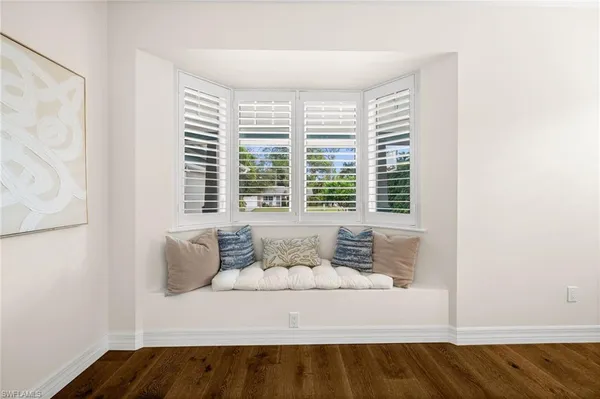 a living room with furniture and large window