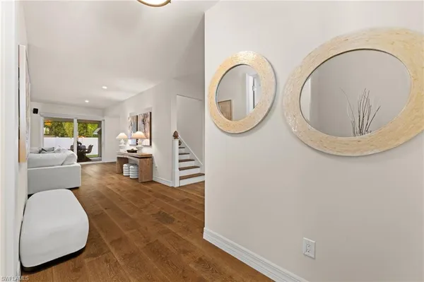 a living room with furniture and a mirror