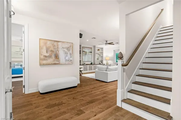 a view of a living room with furniture and wooden floor