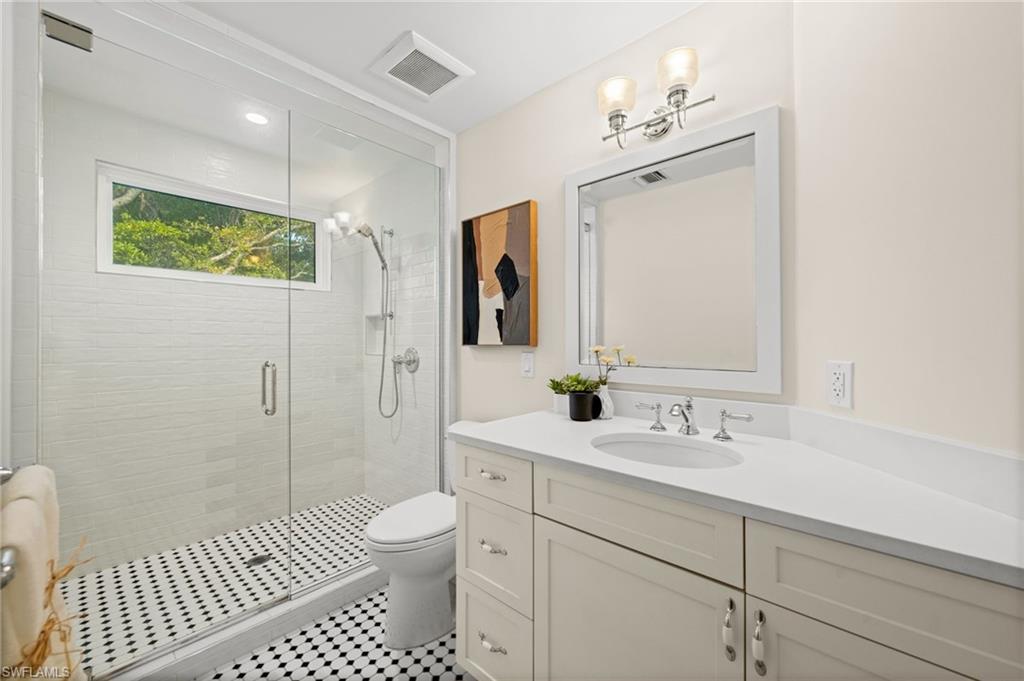 2499 10th Street North Naples, FL 34103 - Photo 22 of 33 a bathroom with a sink a toilet and shower