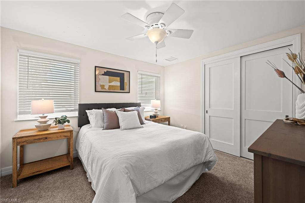 2499 10th Street North Naples, FL 34103 - Photo 28 of 33 a bedroom with a bed and a chandelier