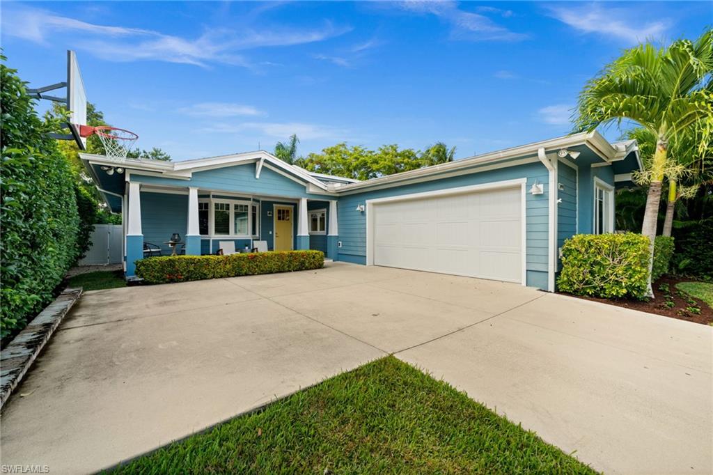 2499 10th Street North Naples, FL 34103 - Photo 30 of 33 a front view of a house with a garden and plants