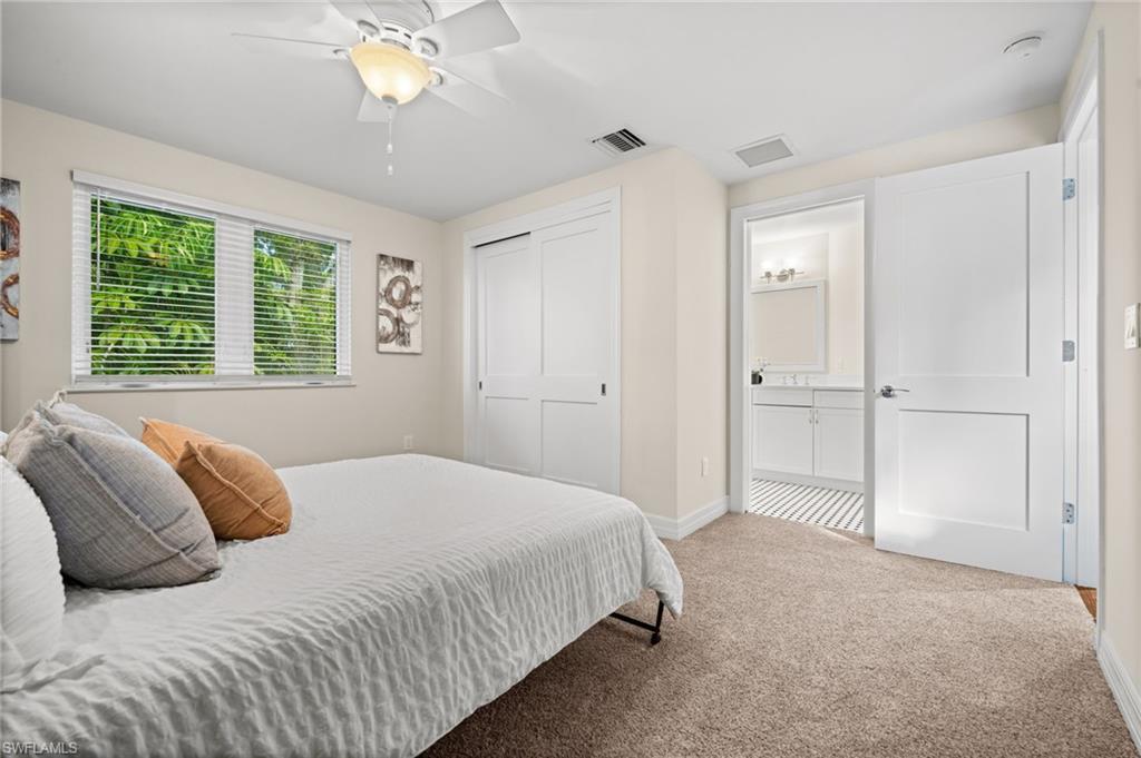 2499 10th Street North Naples, FL 34103 - Photo 30 of 33 a bedroom with a bed and a chandelier