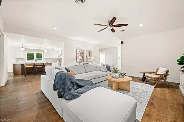 a living room with furniture potted plant and a window