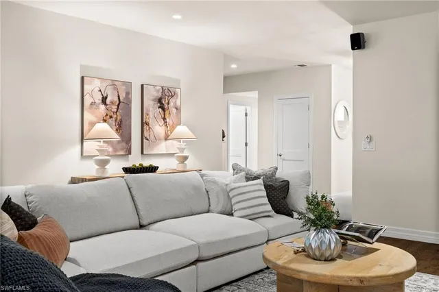 a living room with furniture and a lamp