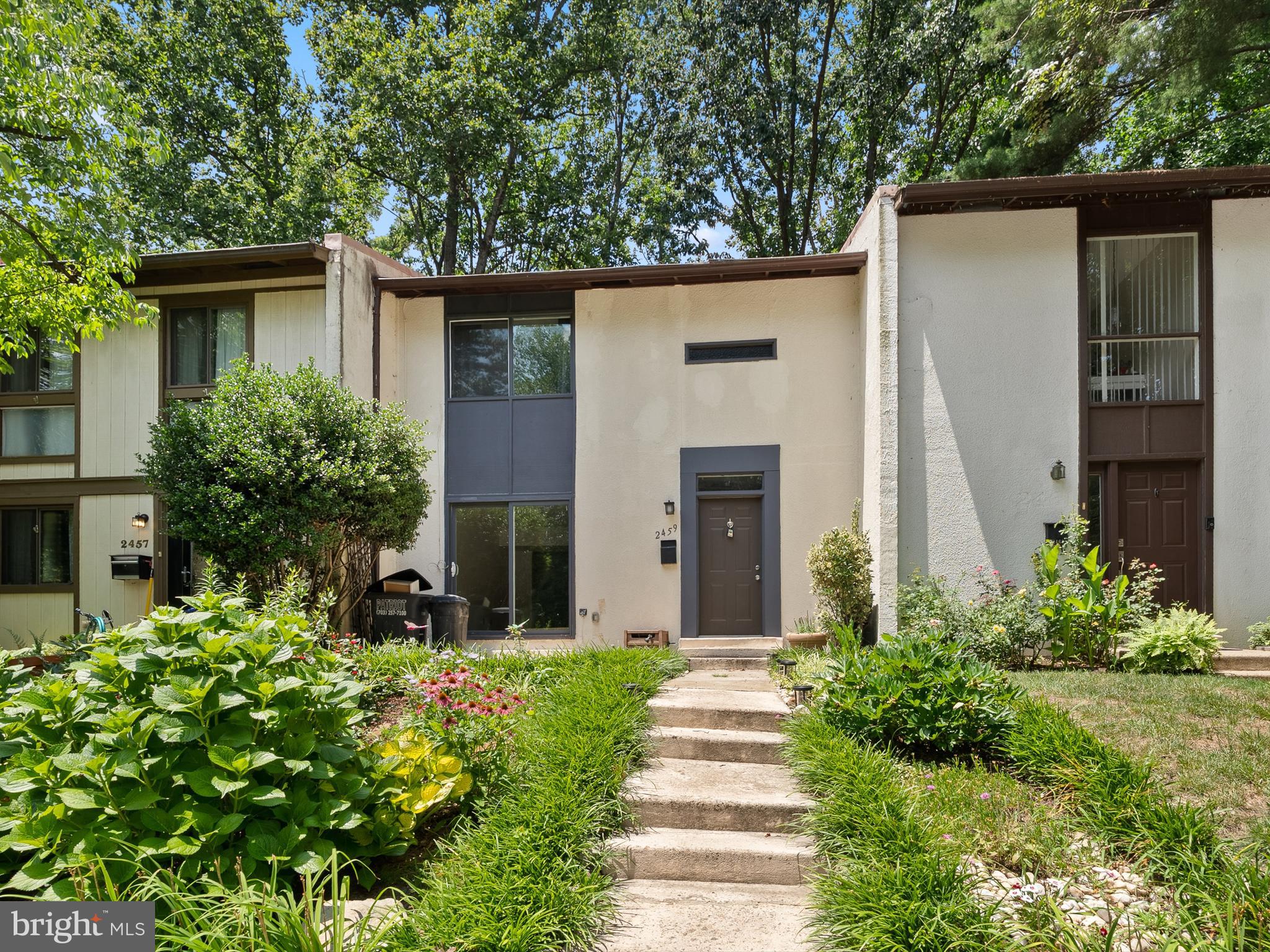 2459 Pyrenees Court Reston, VA 20191 - Photo 1 of 28 a view of a house with potted plants and a table and chairs