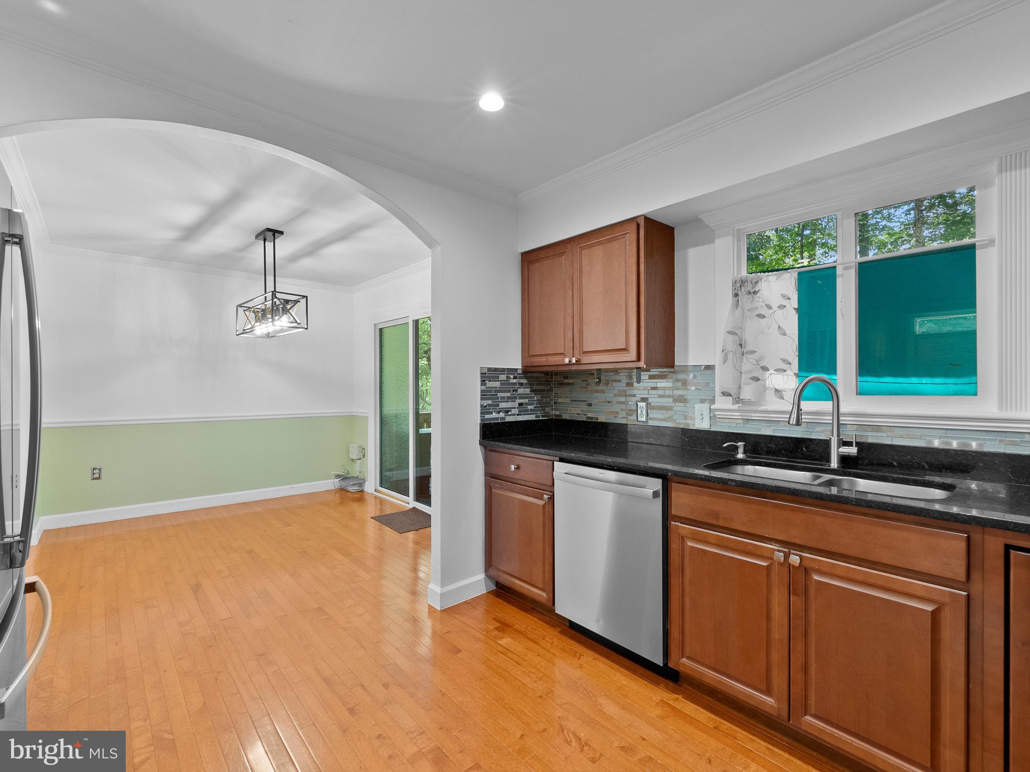 2459 Pyrenees Court Reston, VA 20191 - Photo 11 of 28 a kitchen with granite countertop a sink stainless steel appliances white cabinets and a window