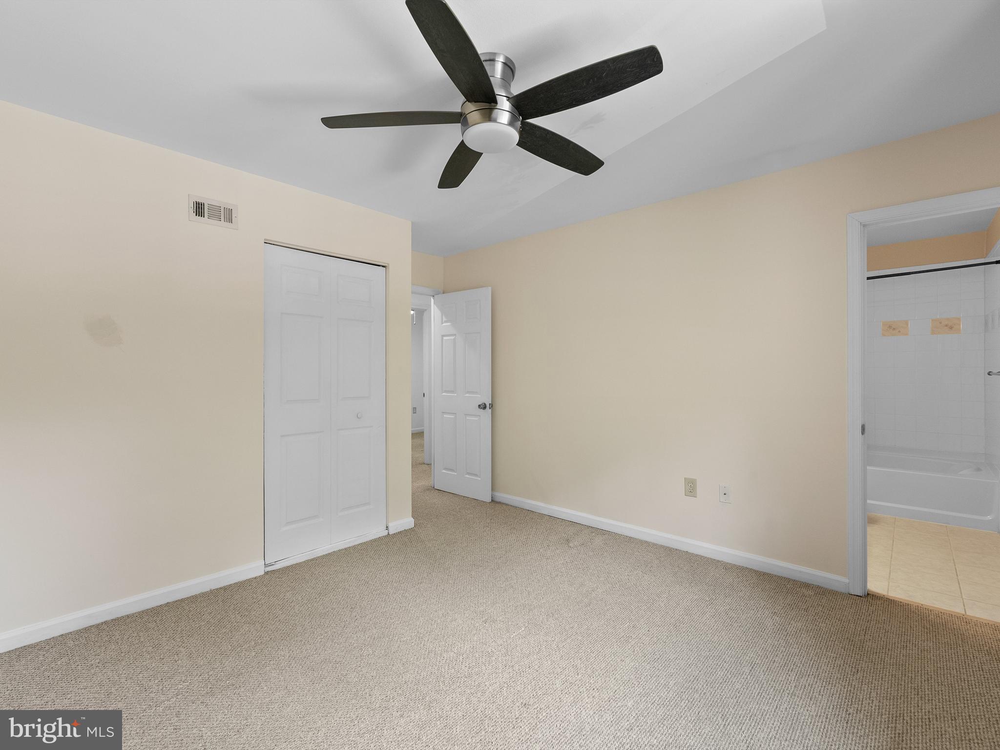 2459 Pyrenees Court Reston, VA 20191 - Photo 19 of 28 an empty room with a ceiling fan and carpet