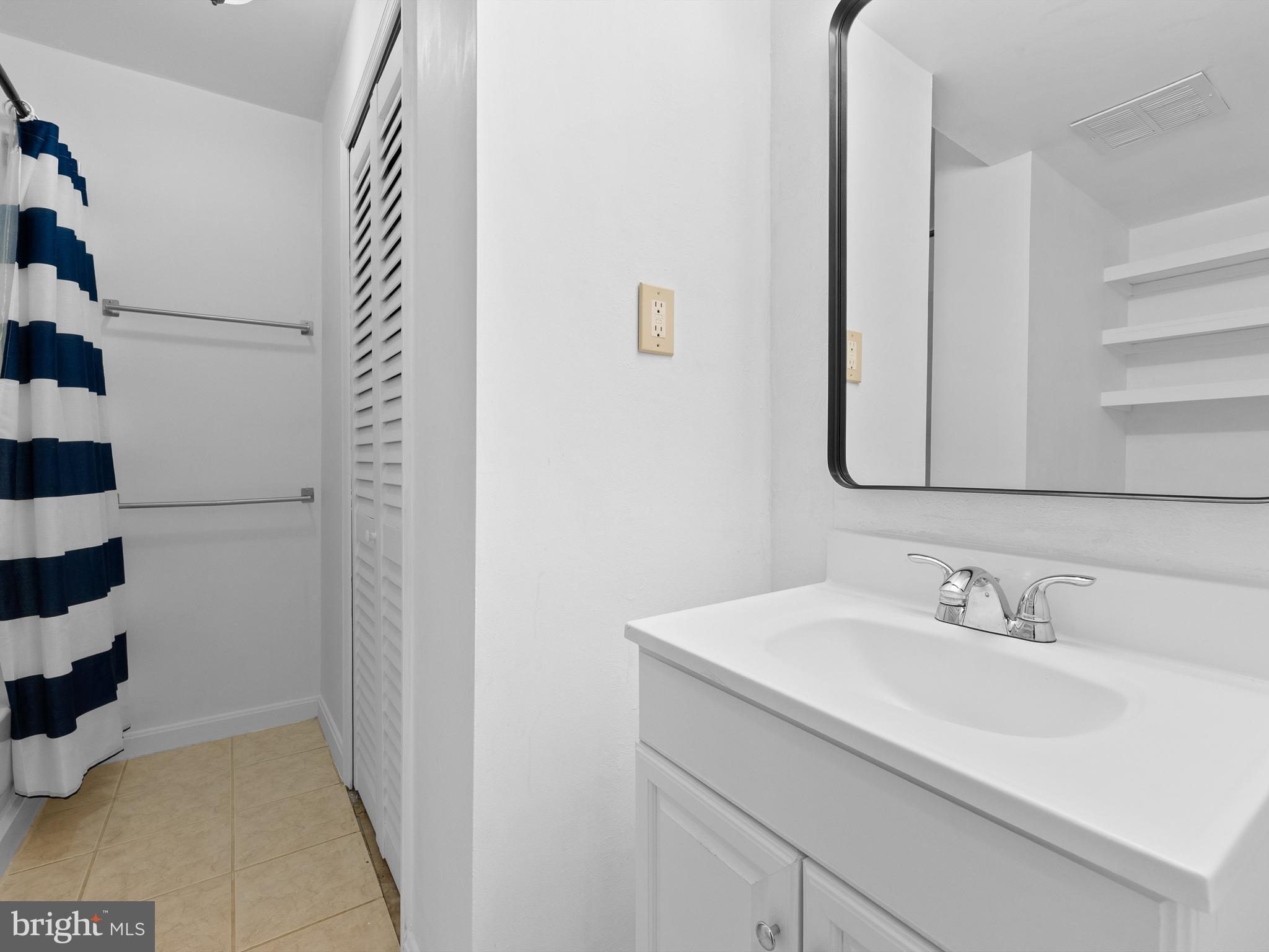 2459 Pyrenees Court Reston, VA 20191 - Photo 22 of 28 a bathroom with a sink and a mirror