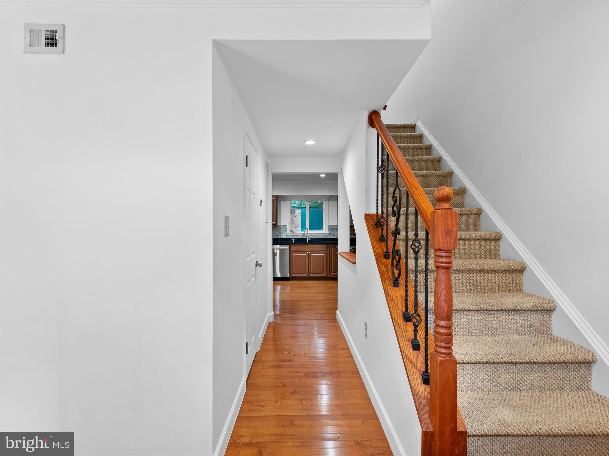 2459 Pyrenees Court Reston, VA 20191 - Photo 3 of 28 a view of a hallway with wooden floor and stairs
