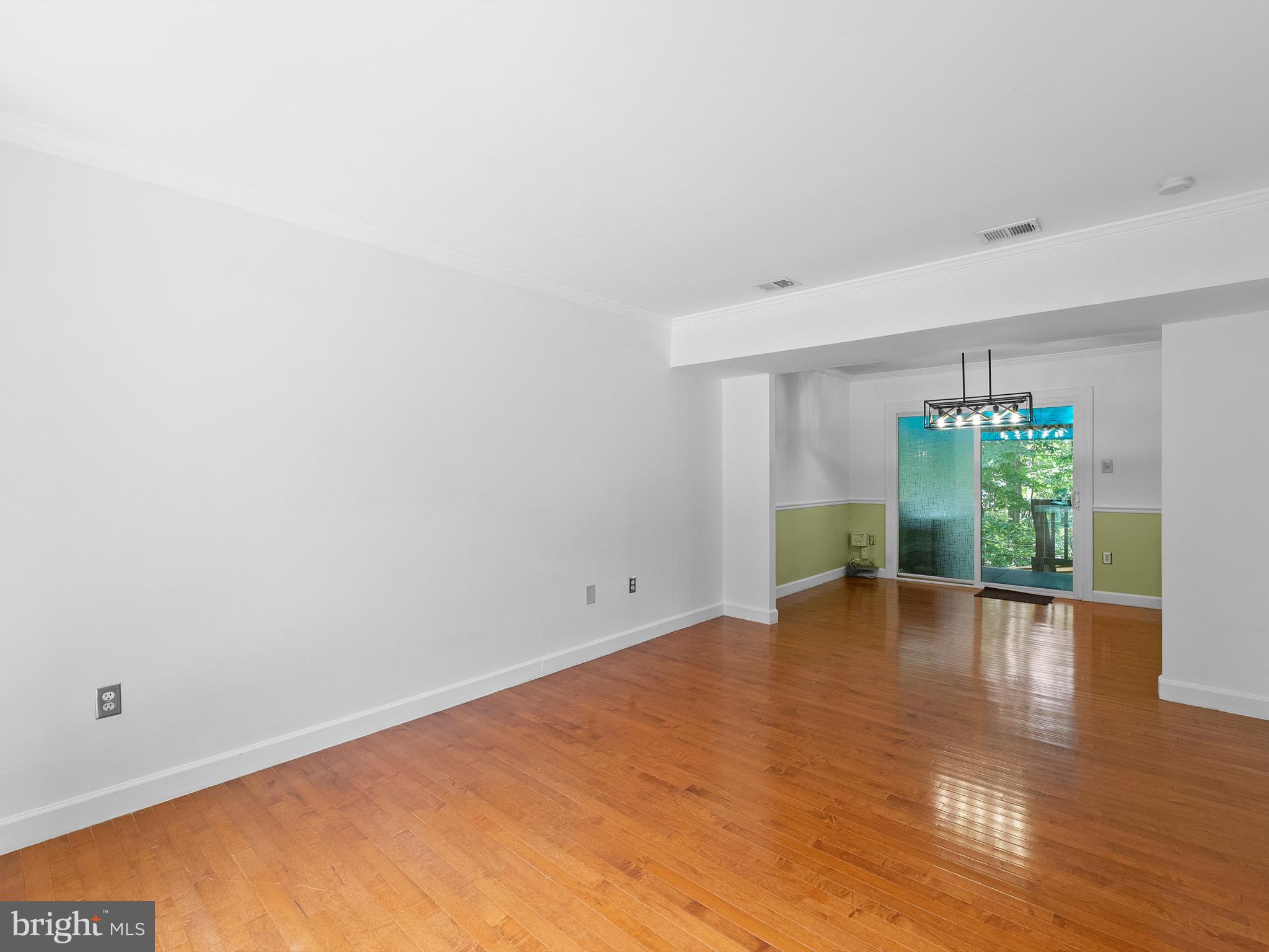 2459 Pyrenees Court Reston, VA 20191 - Photo 5 of 28 a view of an empty room with plants and wooden floor