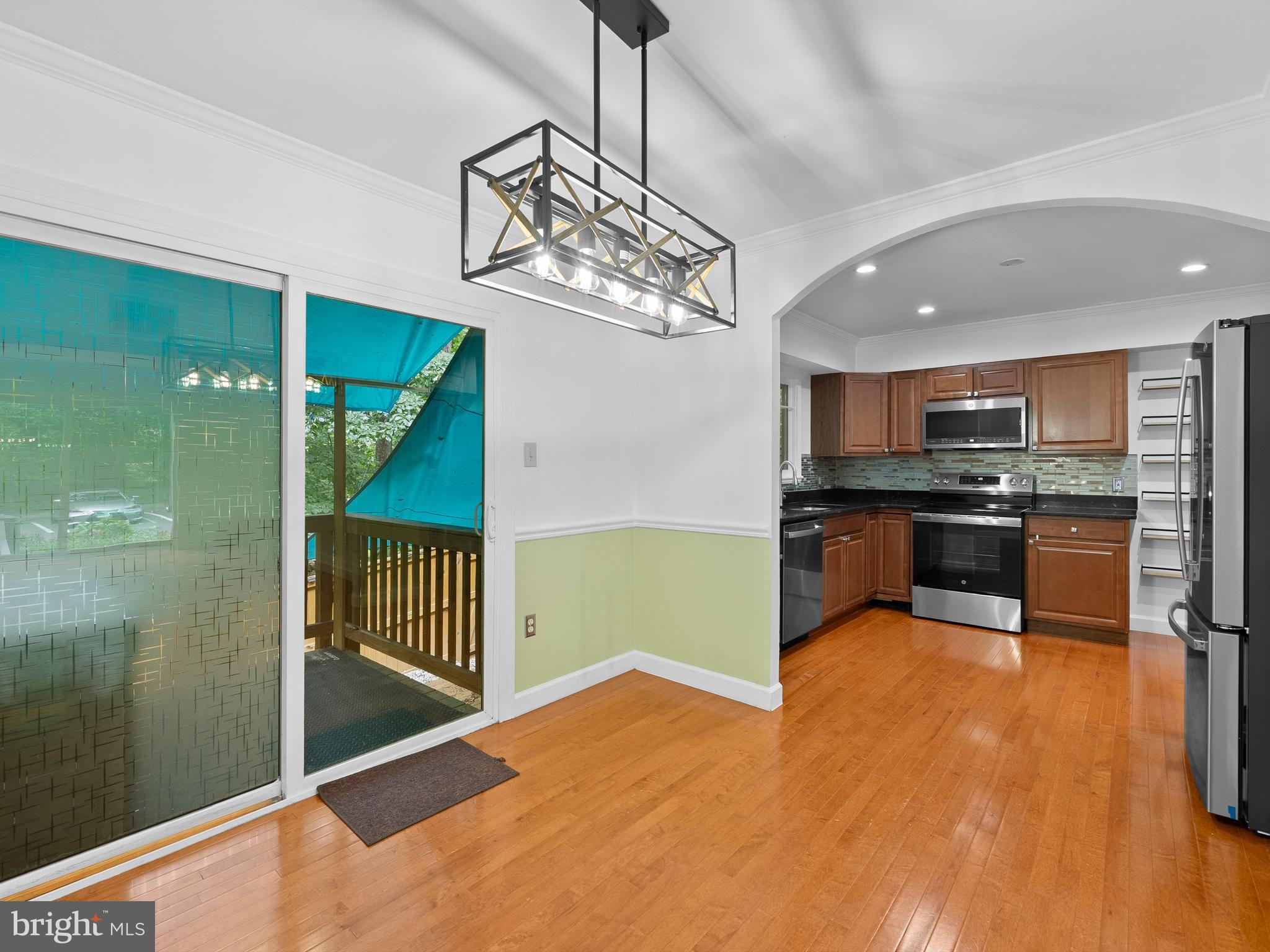 2459 Pyrenees Court Reston, VA 20191 - Photo 7 of 28 a kitchen with stainless steel appliances kitchen island granite countertop a refrigerator and stove