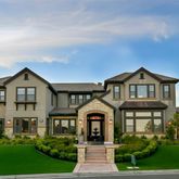 a front view of a house wth yard and green space