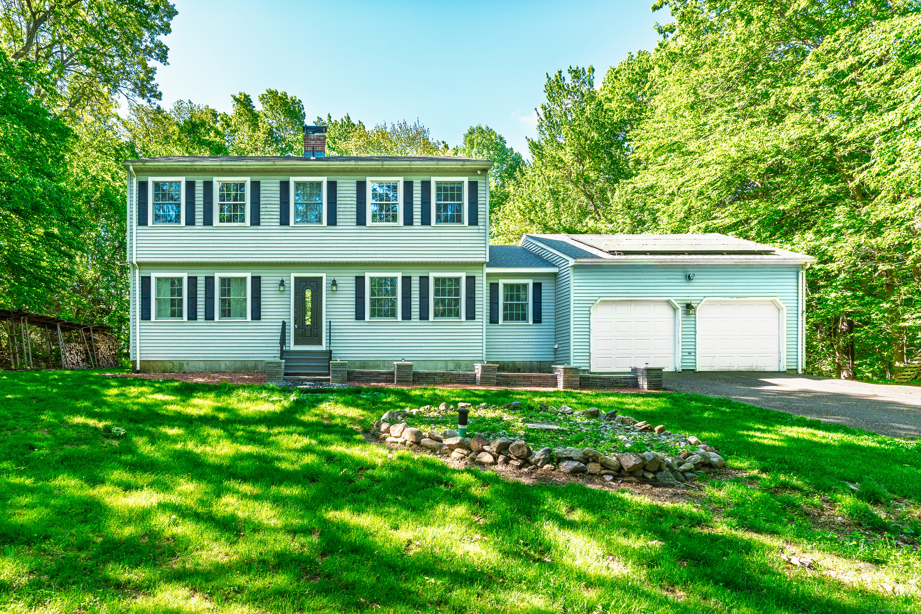 27 Porter Road Wolcott, CT 06716 - Photo 1 of 1 a front view of a house with a garden