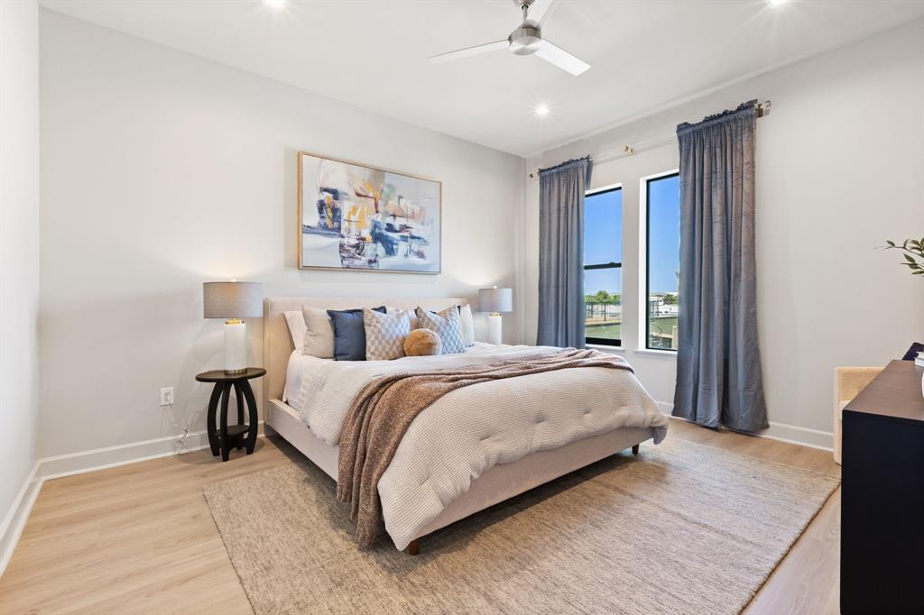 1900 South Ervay Street, Unit 508 Dallas, TX 75215 - Photo 13 of 39 a bedroom with a bed and a chandelier