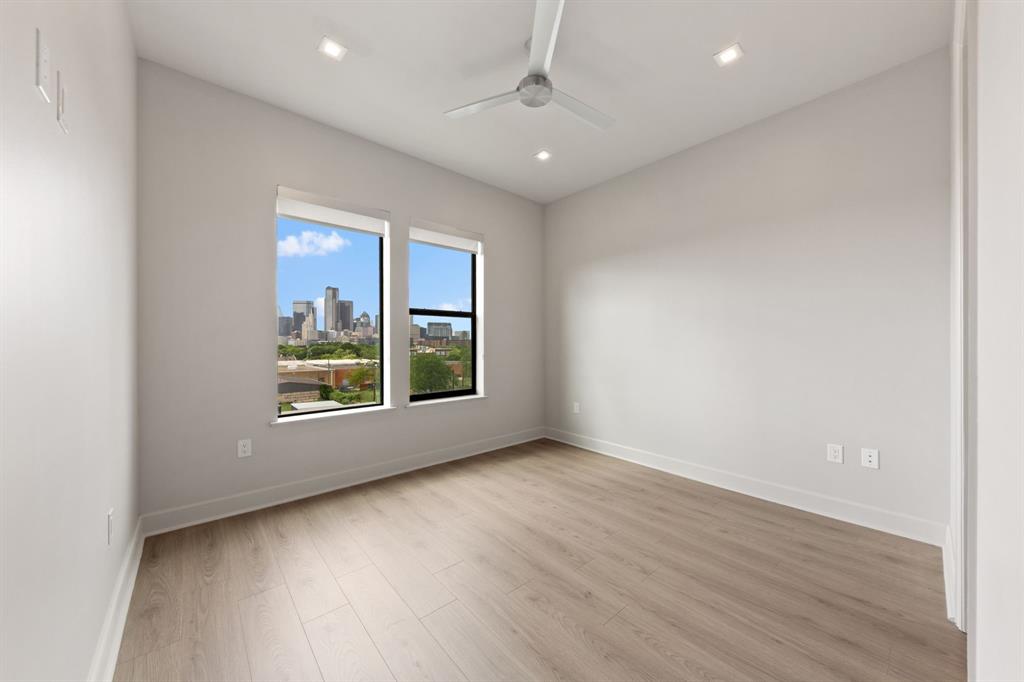 1900 South Ervay Street, Unit 508 Dallas, TX 75215 - Photo 15 of 36 an empty room with wooden floor and windows