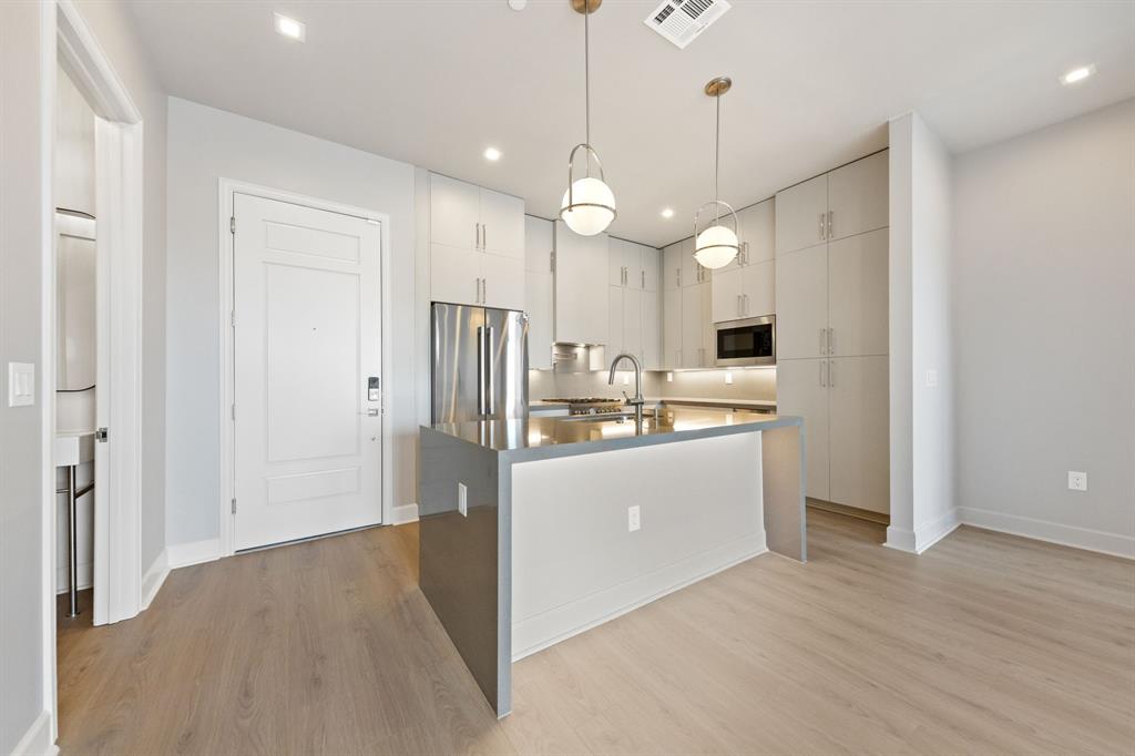 1900 South Ervay Street, Unit 508 Dallas, TX 75215 - Photo 2 of 36 a kitchen view with stainless steel appliances a refrigerator and microwave