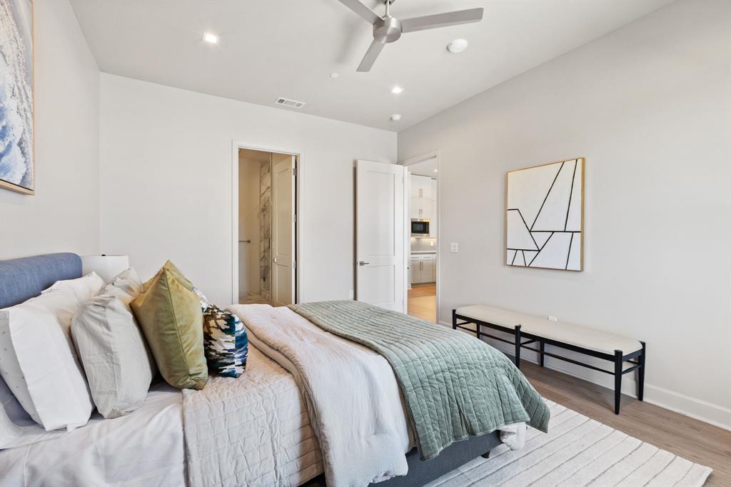 1900 South Ervay Street, Unit 508 Dallas, TX 75215 - Photo 27 of 39 a bedroom with a bed and wooden floor