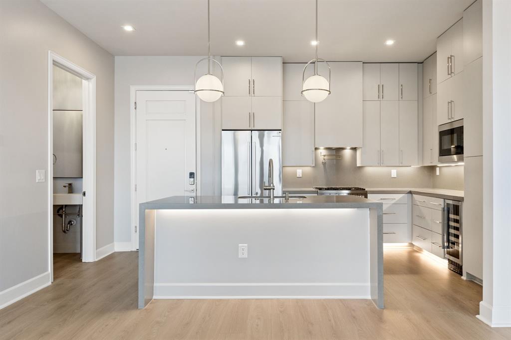 1900 South Ervay Street, Unit 508 Dallas, TX 75215 - Photo 4 of 36 a kitchen with kitchen island stainless steel appliances a refrigerator oven a sink and a stove