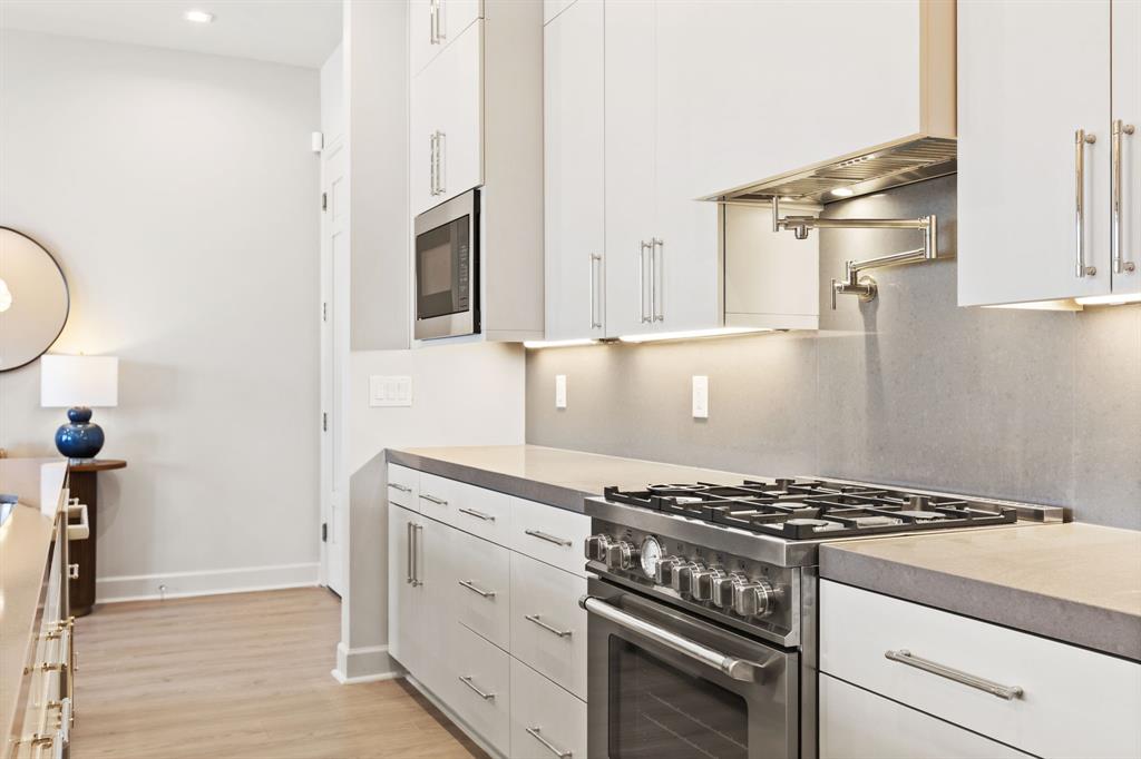 1900 South Ervay Street, Unit 508 Dallas, TX 75215 - Photo 5 of 39 a kitchen with granite countertop a stove and a sink