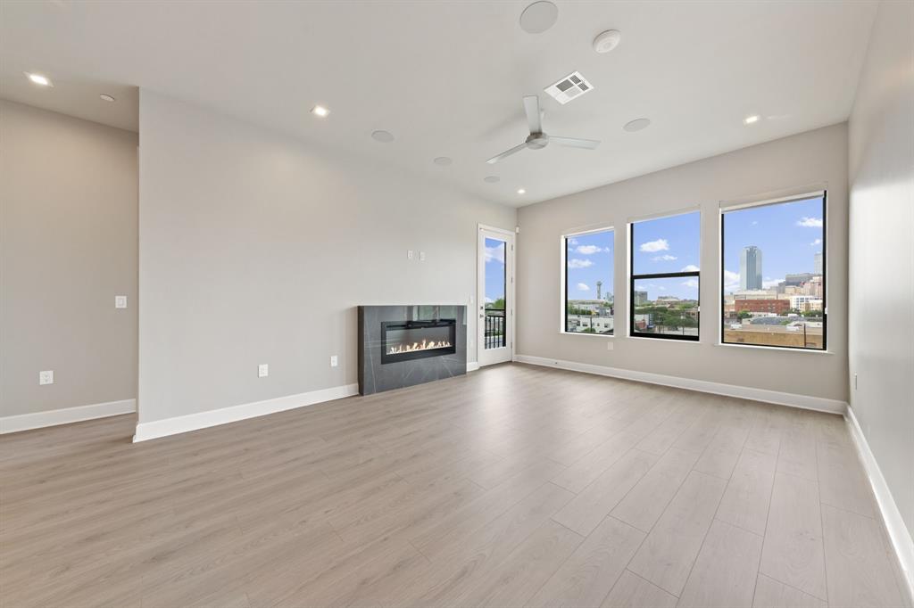 1900 South Ervay Street, Unit 508 Dallas, TX 75215 - Photo 6 of 36 a view of an empty room with a window and wooden floor