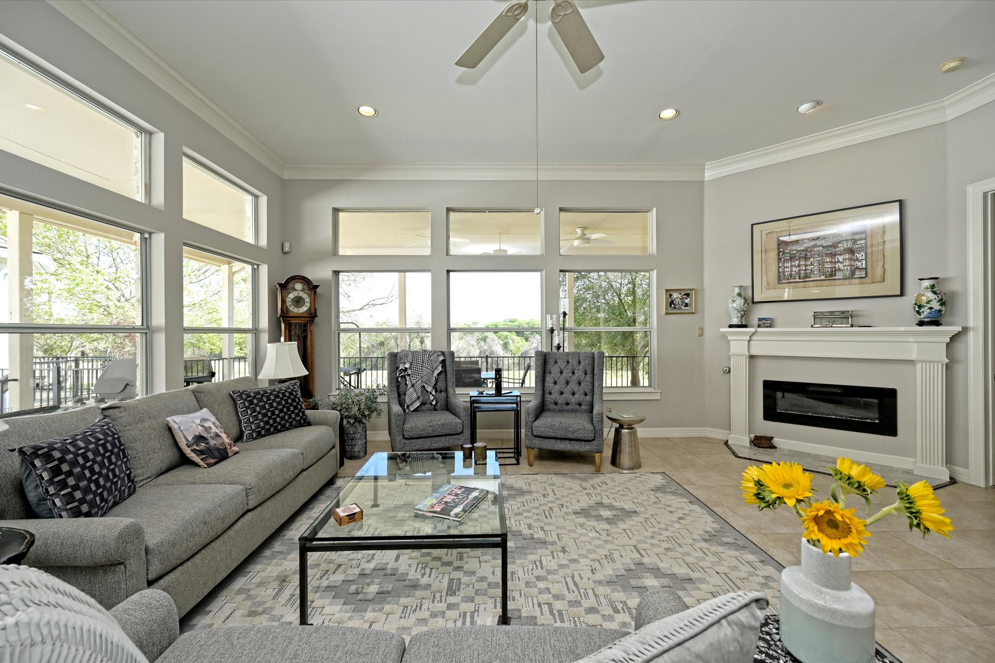 4912 Interlachen Lane Austin, TX 78747 - Photo 16 of 39 a living room with furniture a fireplace and a floor to ceiling window