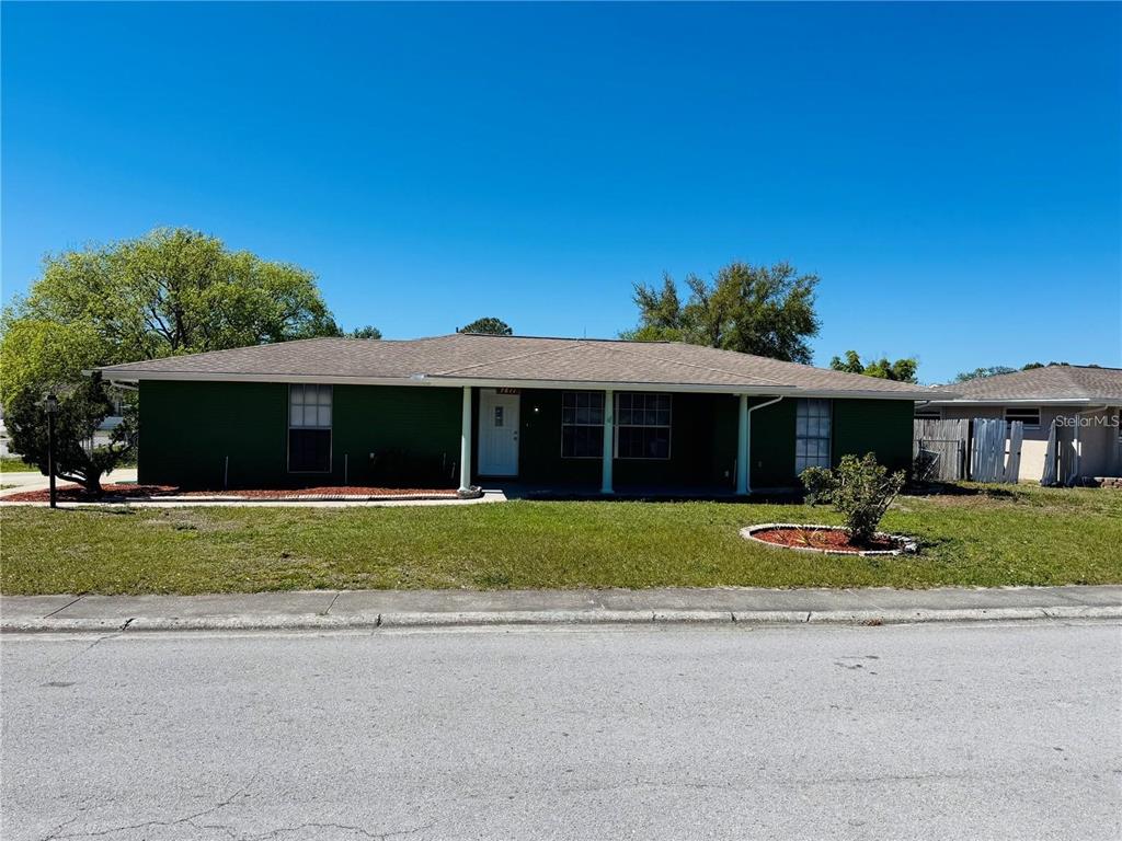 a front view of a house with a yard and a garage