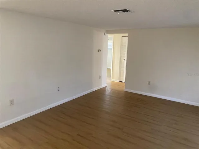a view of an empty room and wooden floor