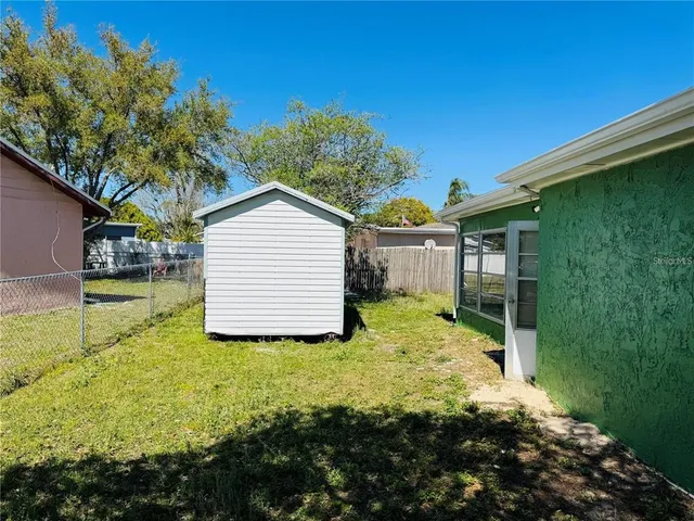 a view of backyard of house with green space