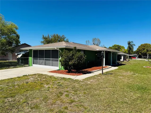 a view of a house with a yard and tree s