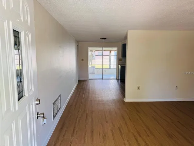 a view of hallway with wooden floor