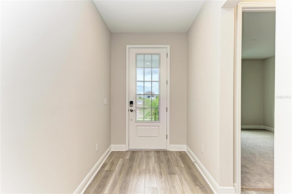 17915 Cropside Trail Lakewood Ranch, FL 34211 - Photo 11 of 33 an empty room with wooden floor and windows
