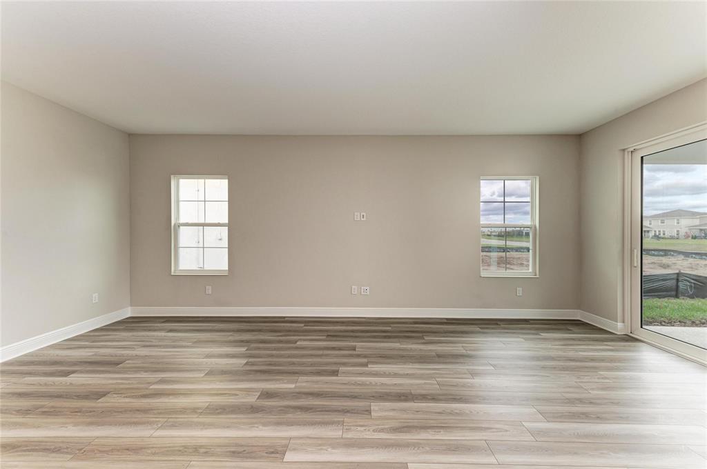 17915 Cropside Trail Lakewood Ranch, FL 34211 - Photo 19 of 33 a view of an empty room with wooden floor and a window